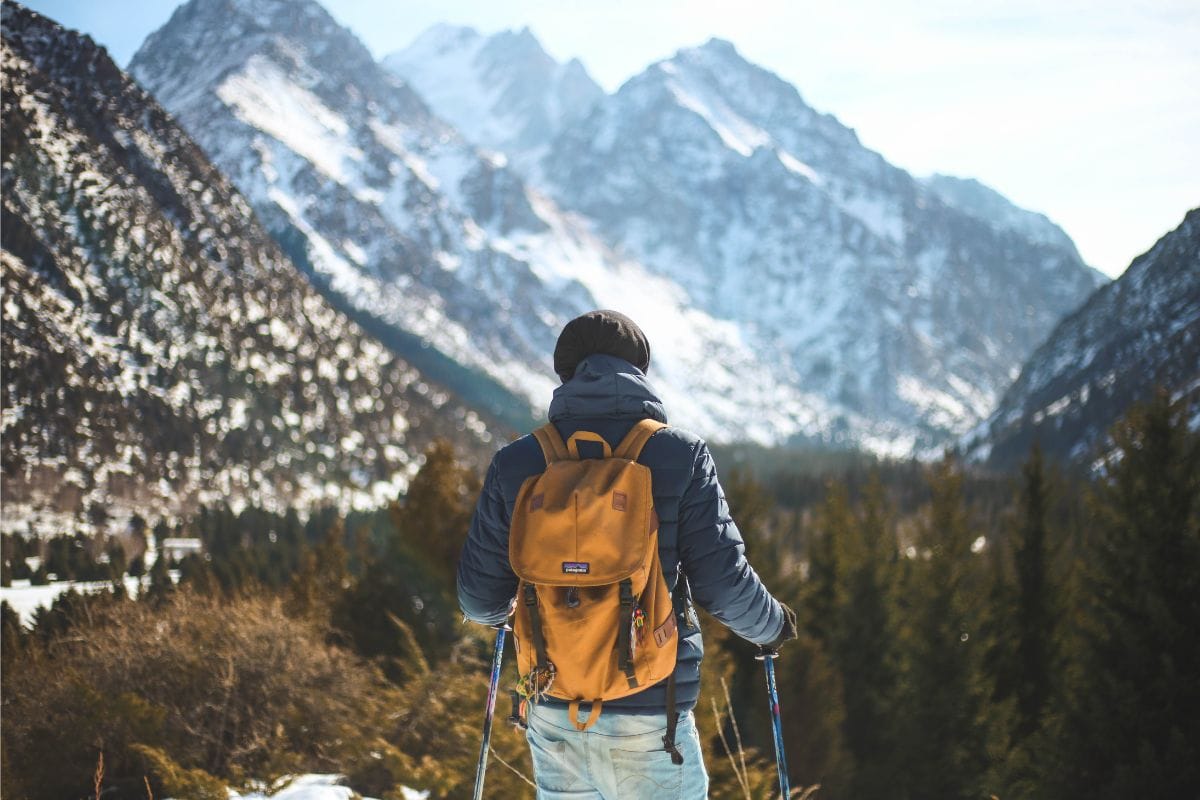 man hiking in snowy mountains